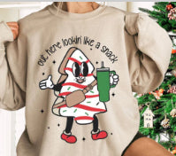Beige sweatshirt with cartoon character design and text on a Christmas-themed background